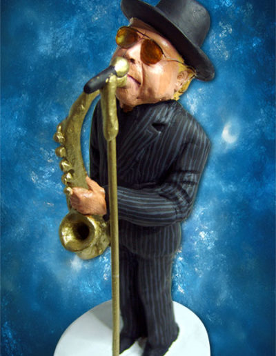 Statuina di terracotta del jazzista Van Morrison mentre suona il suo sassofono , con abito gessato scuro e il microfono ad asta dorato.Fatto a mano in stile statuine di Napoli